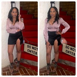 Satin light pink top with black satin mini skirt.